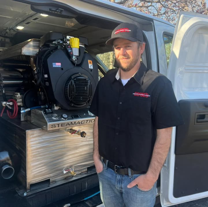 A person beside carpet-cleaning equipment in the van, from Clyde’s official Facebook profile